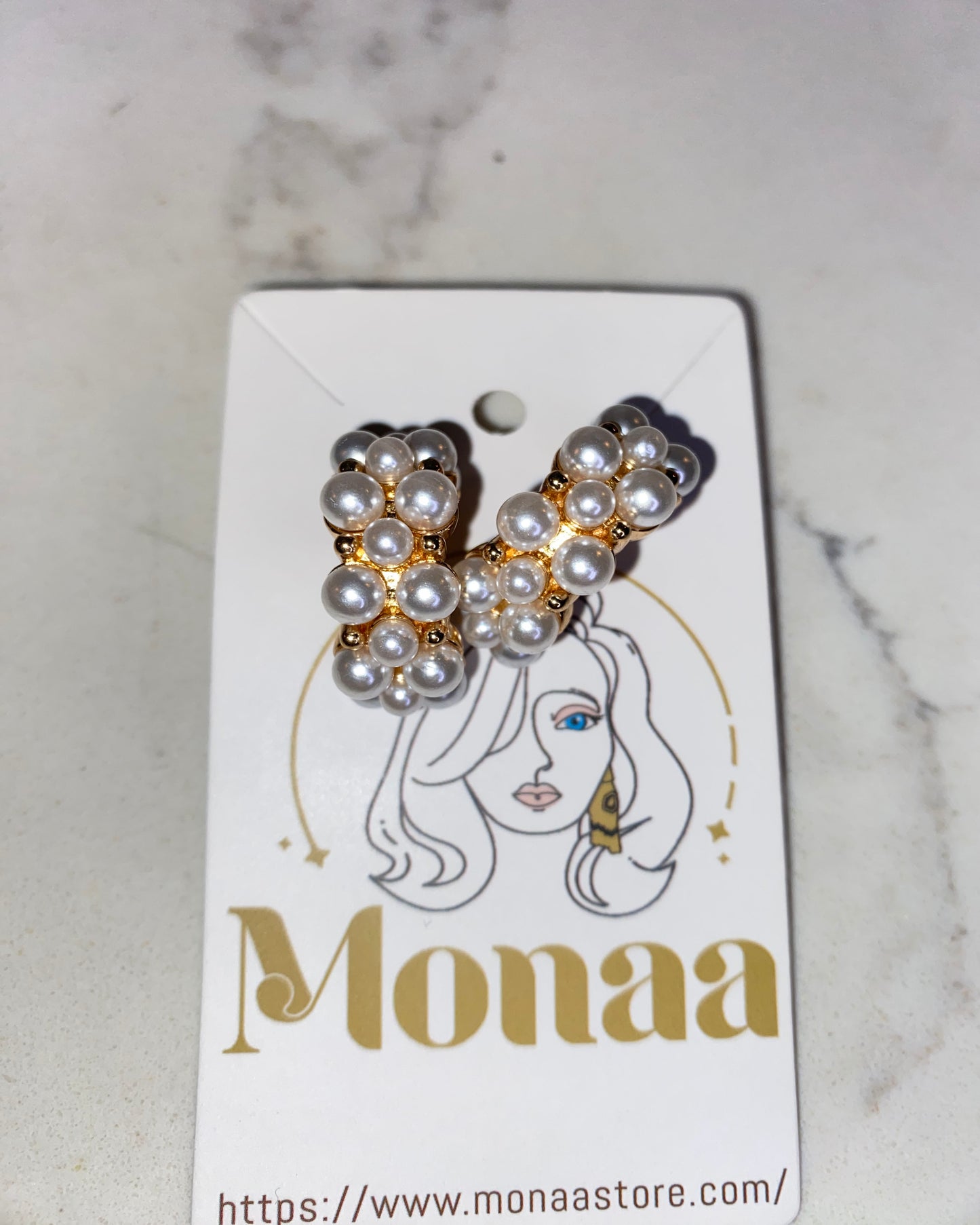 Modern Glam: Gold pearls loop earrings.