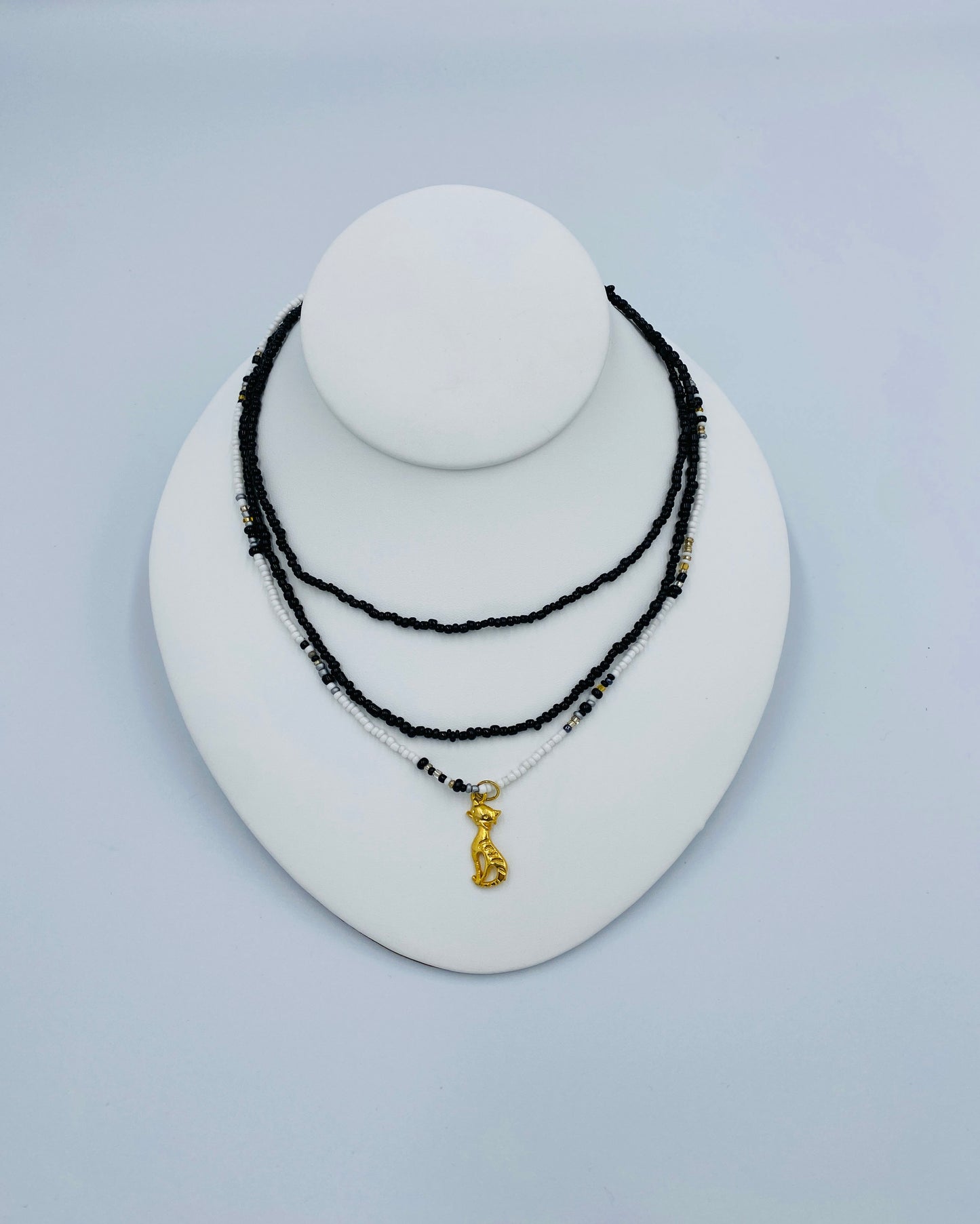 Gold Cat pendant in a Black and White Necklace