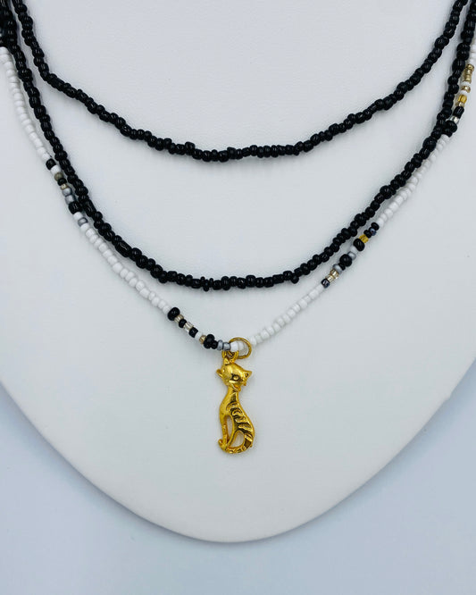 Gold Cat pendant in a Black and White Necklace