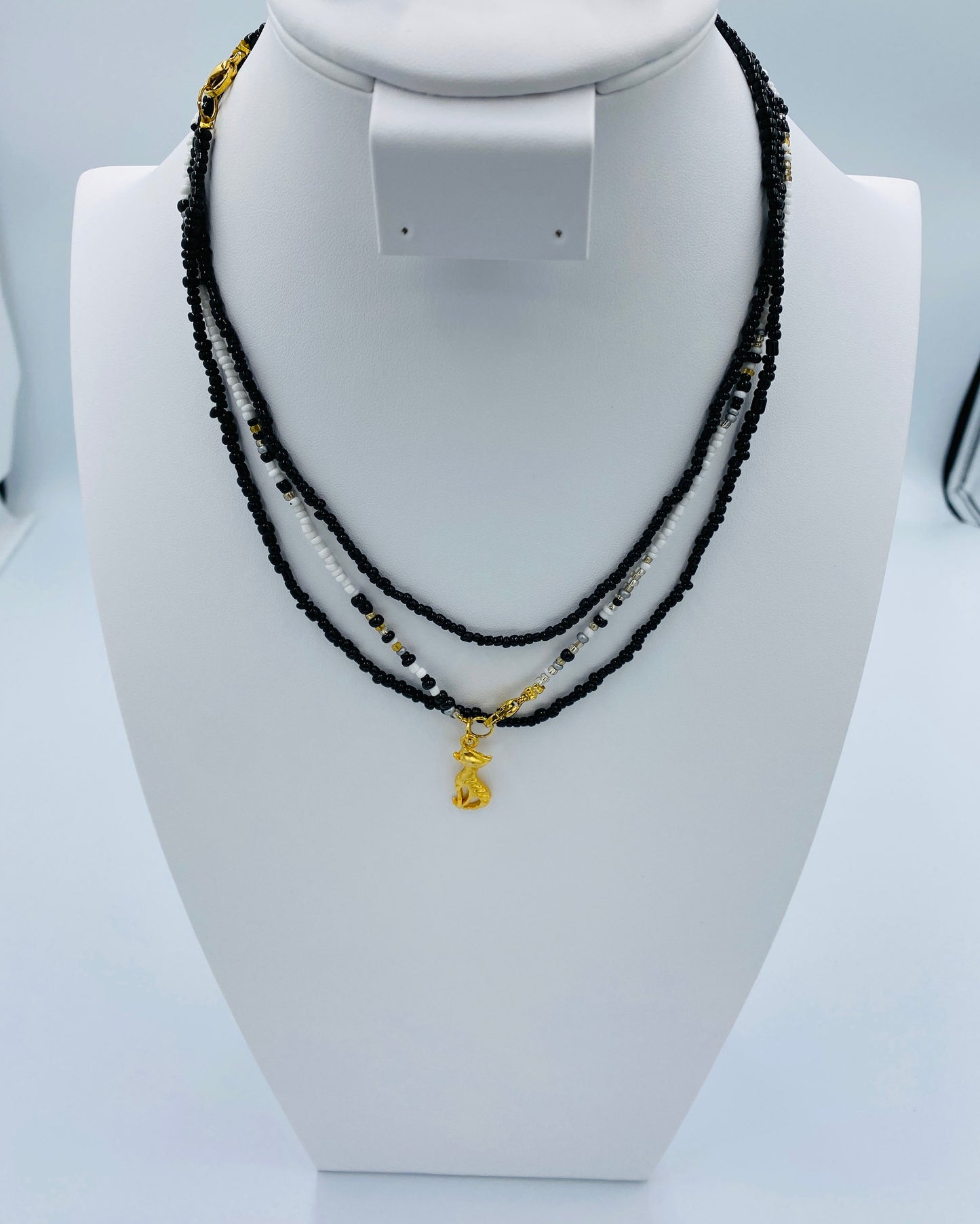 Gold Cat pendant in a Black and White Necklace